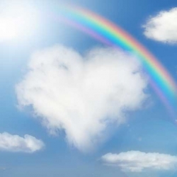Sky with heart shaped cloud and rainbow in the background.
